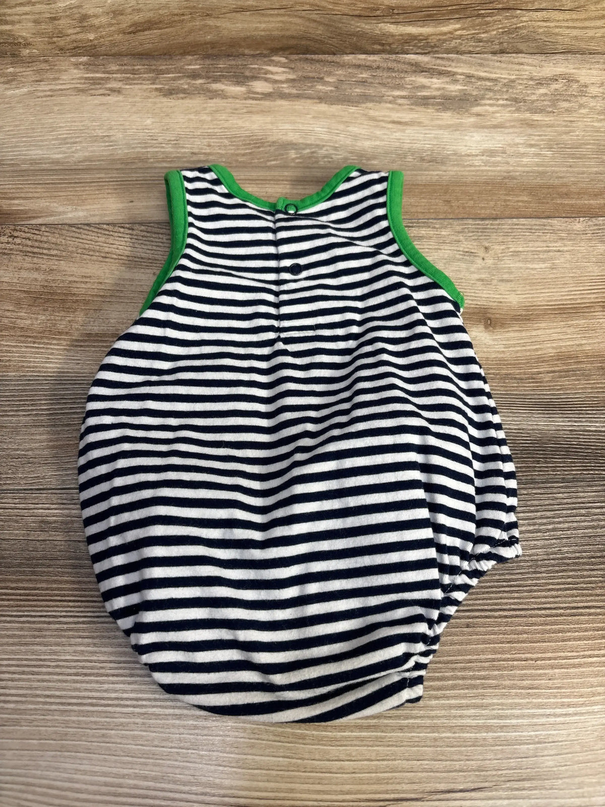 Front view of Banana Split Tractor striped romper in navy and white with green trim, front snaps, and elastic leg openings