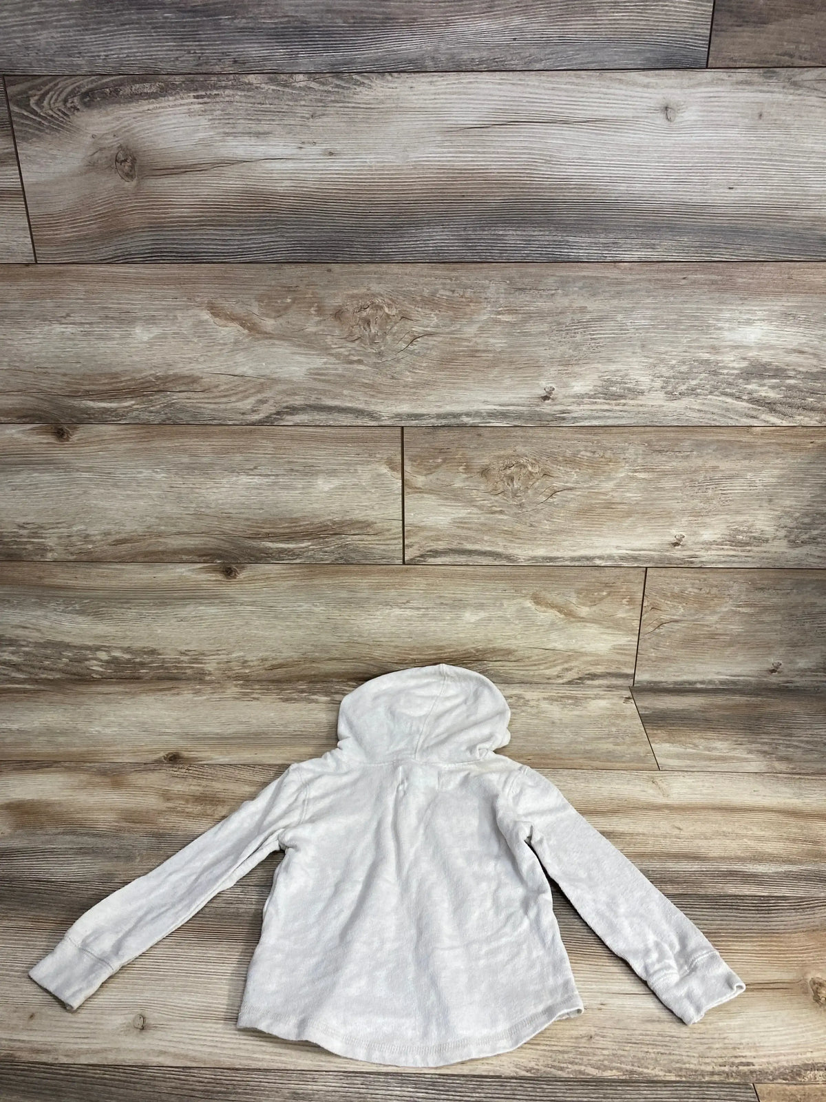 Light gray kids hooded long sleeve shirt displayed on wood background
