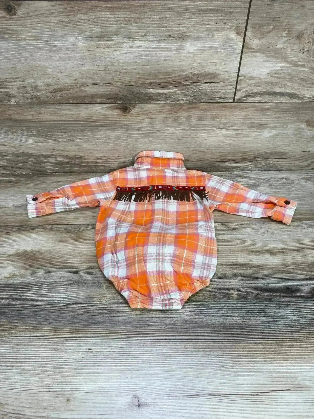 Front view of Oshkosh orange plaid flannel button-up bodysuit showing button-front and snap bottom on white