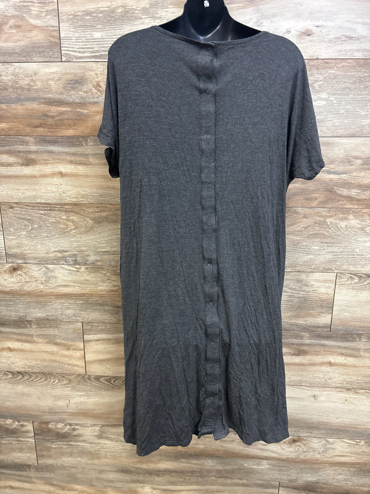 Front view of Frida delivery and nursing gown in grey showing short sleeves and center snap closures on wood background