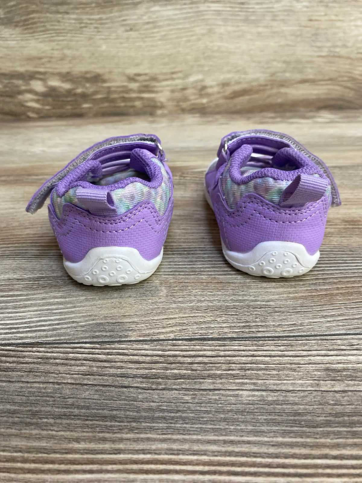 Rear view of FEETCITY wide barefoot water shoes showing white textured soles and Velcro straps on wood background, toddler size 4/5C