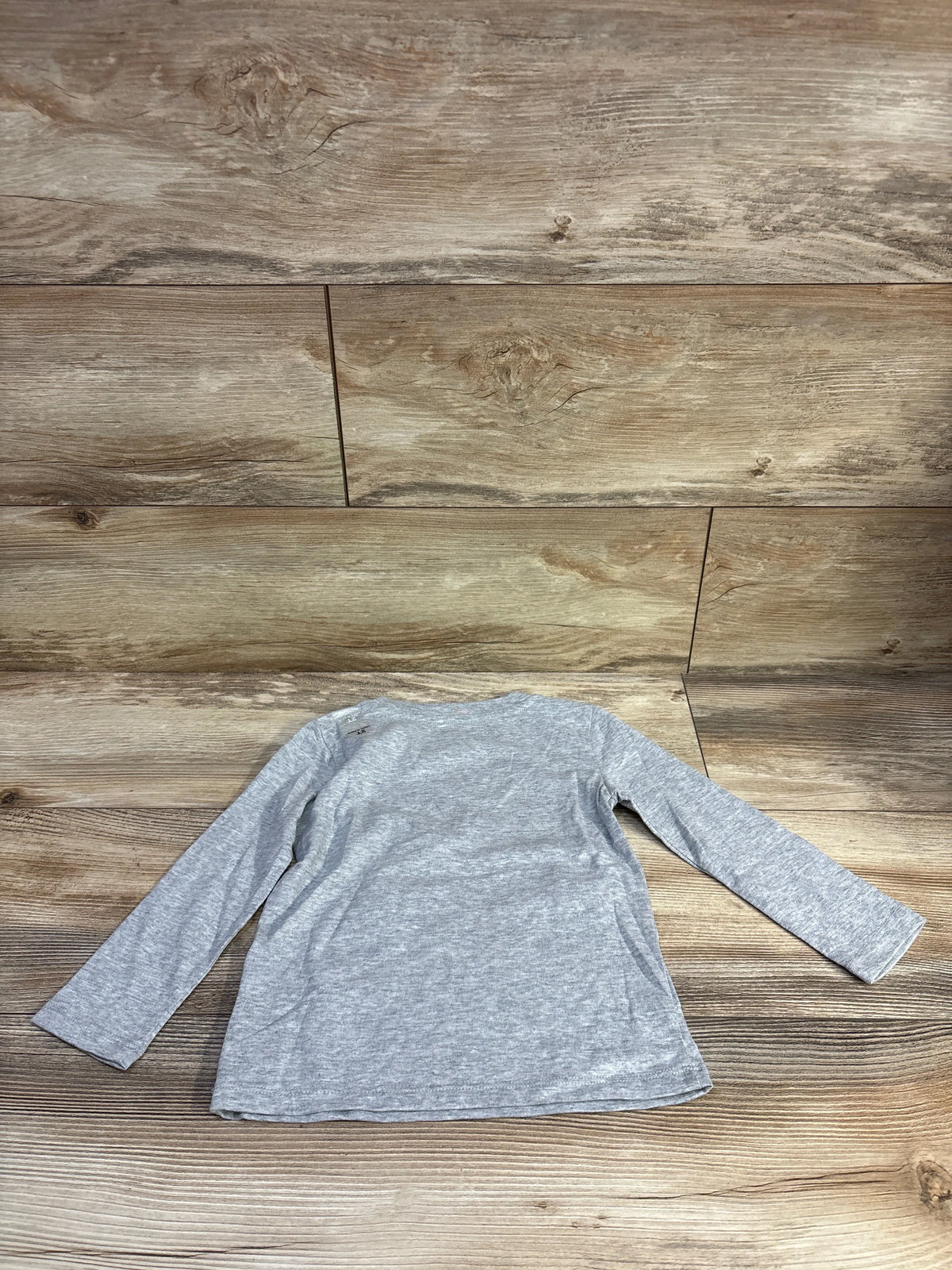 Flat lay of Epic Threads gray long-sleeve toddler shirt size 2T showing front on wood background