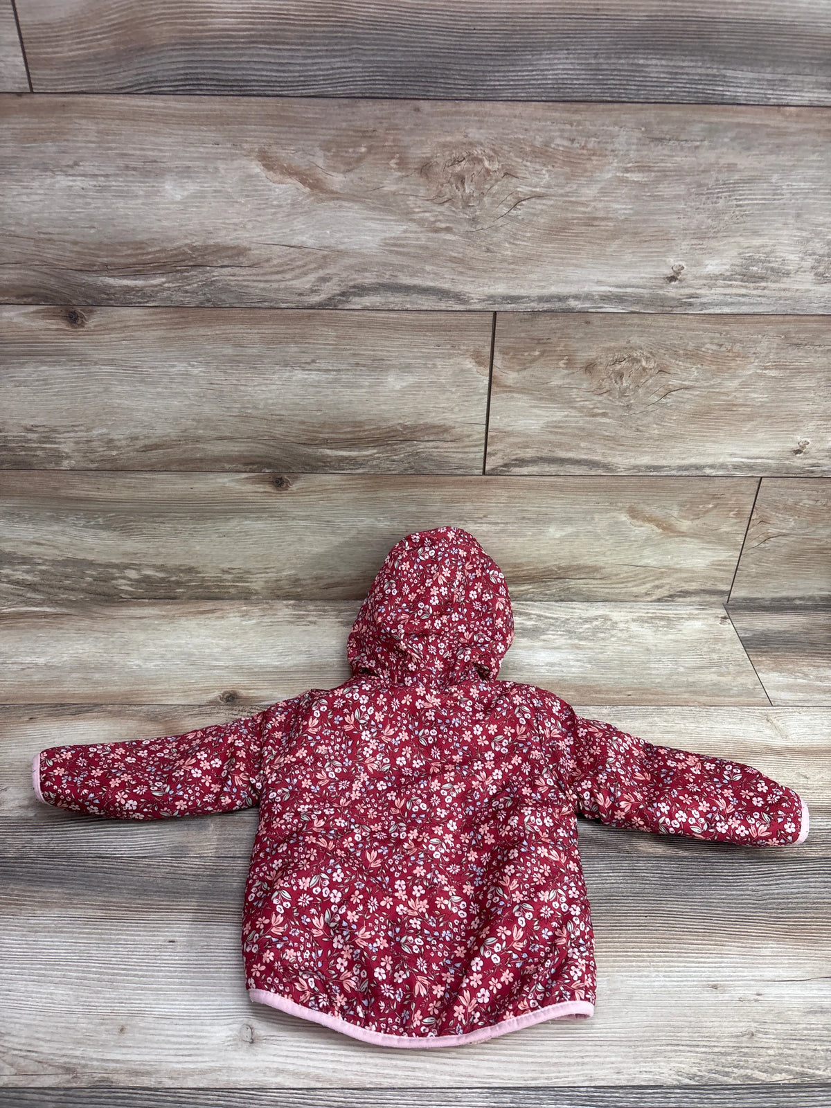 Penelope Mack floral red fur-lined jacket for toddlers on a wood background