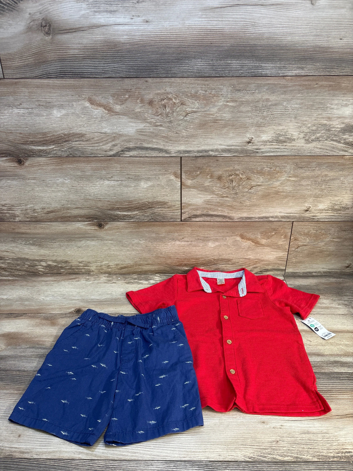 Boys red short sleeve shirt and blue shorts set, casual kids clothing flat lay