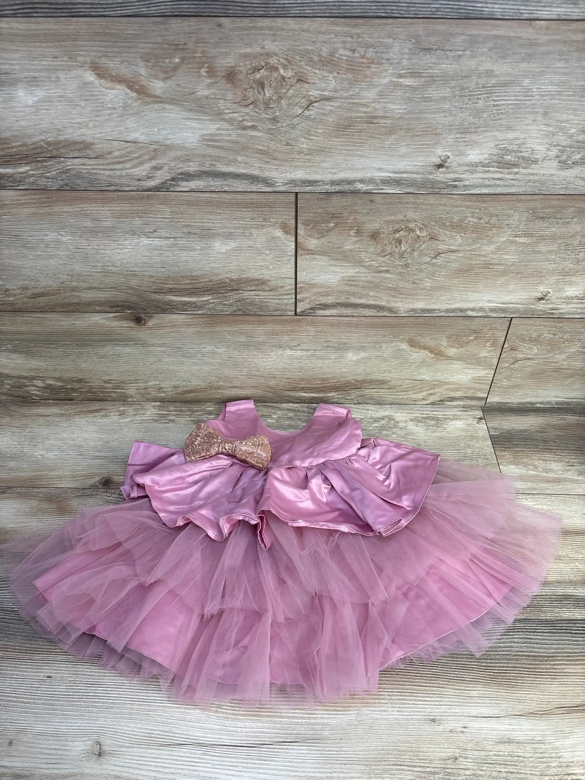 Front view of NNJXD bowknot satin special occasion dress, pink, 9-12 months, showing large bow at waist on white background