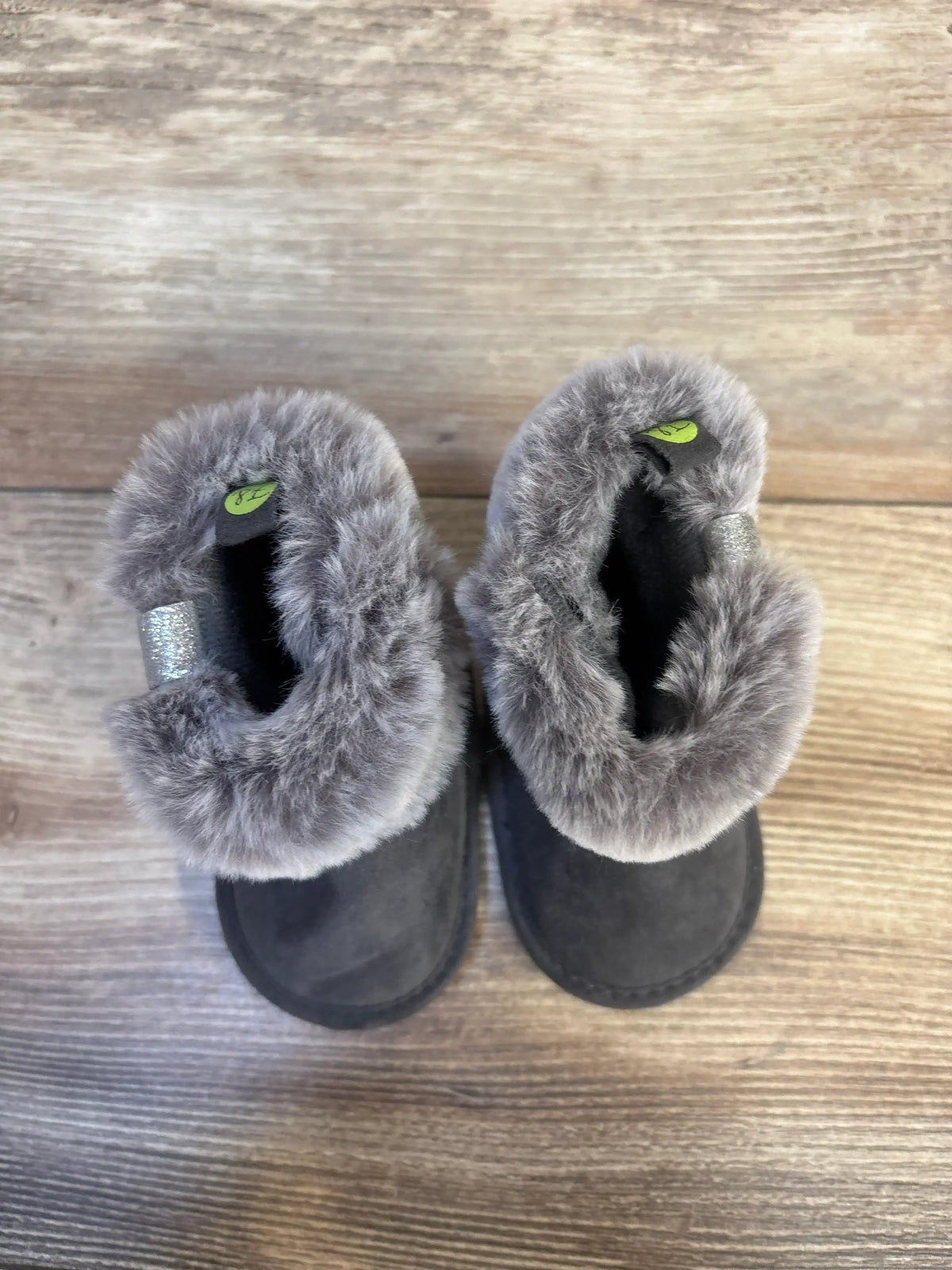 Gray faux fur lined baby boots on wood floor, toddler winter footwear resale