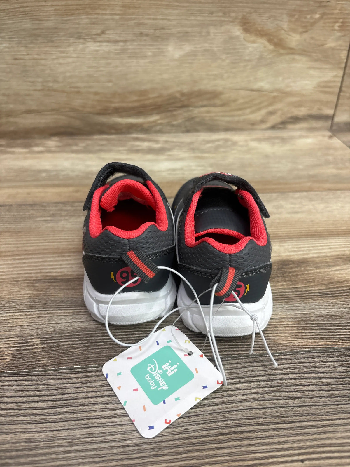 New Disney Baby Cars grey sneakers for infants, size 6c, with red accents and tags.