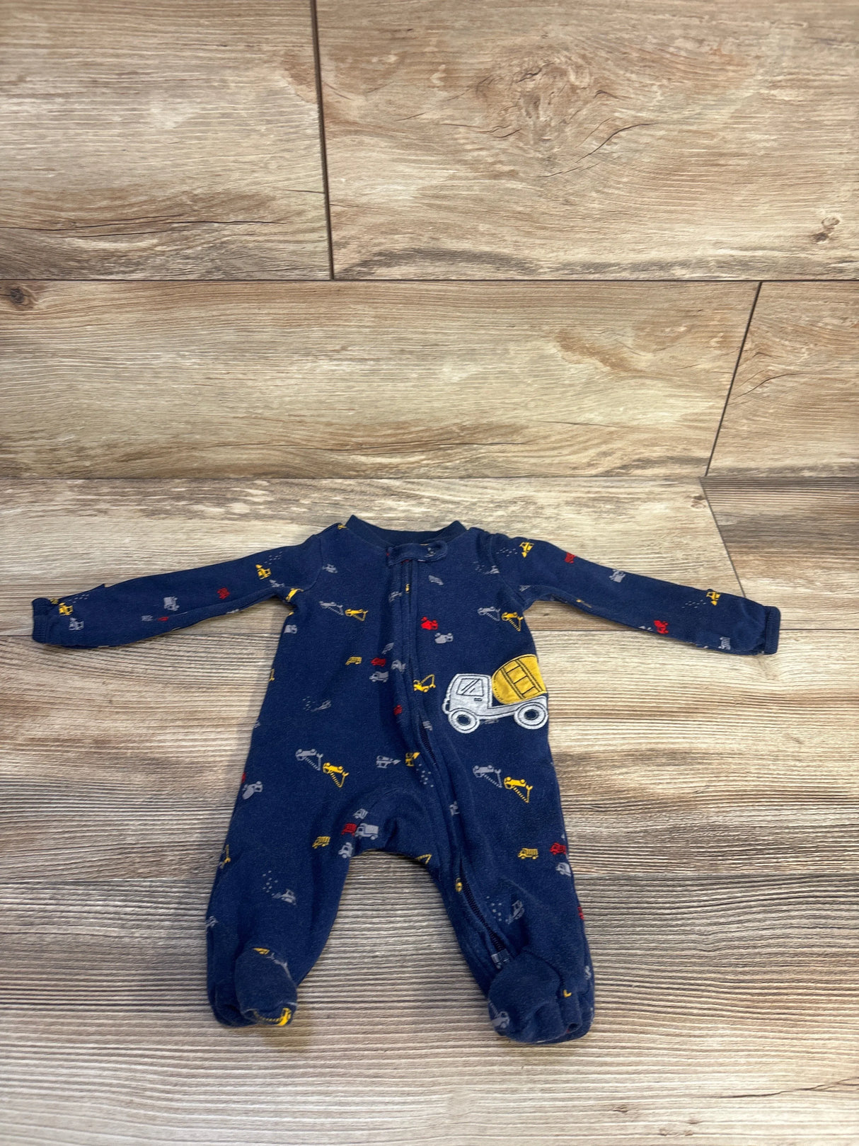 Flat lay of Simple Joys Truck Sleeper Navy sz Newborn showcasing long sleeves, footed legs, and front zipper