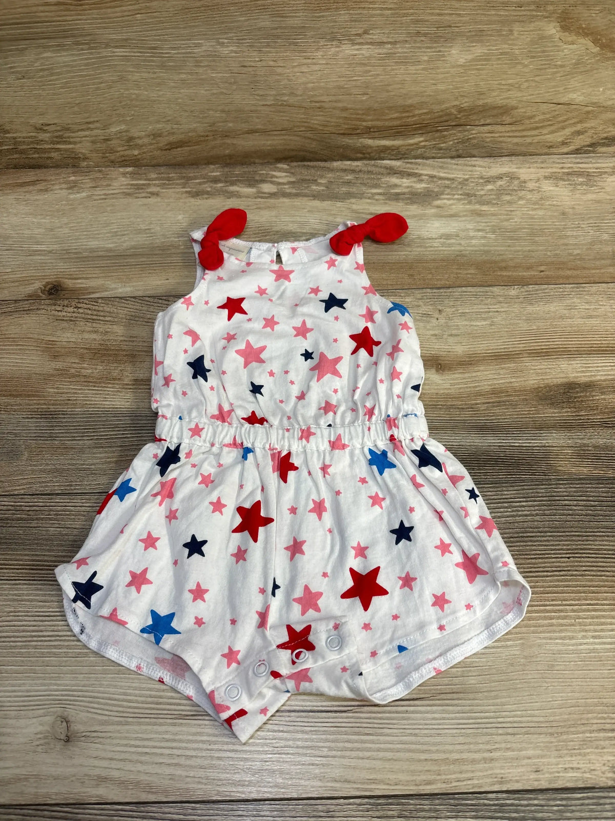 White First Impressions sleeveless romper for babies with red and blue star print