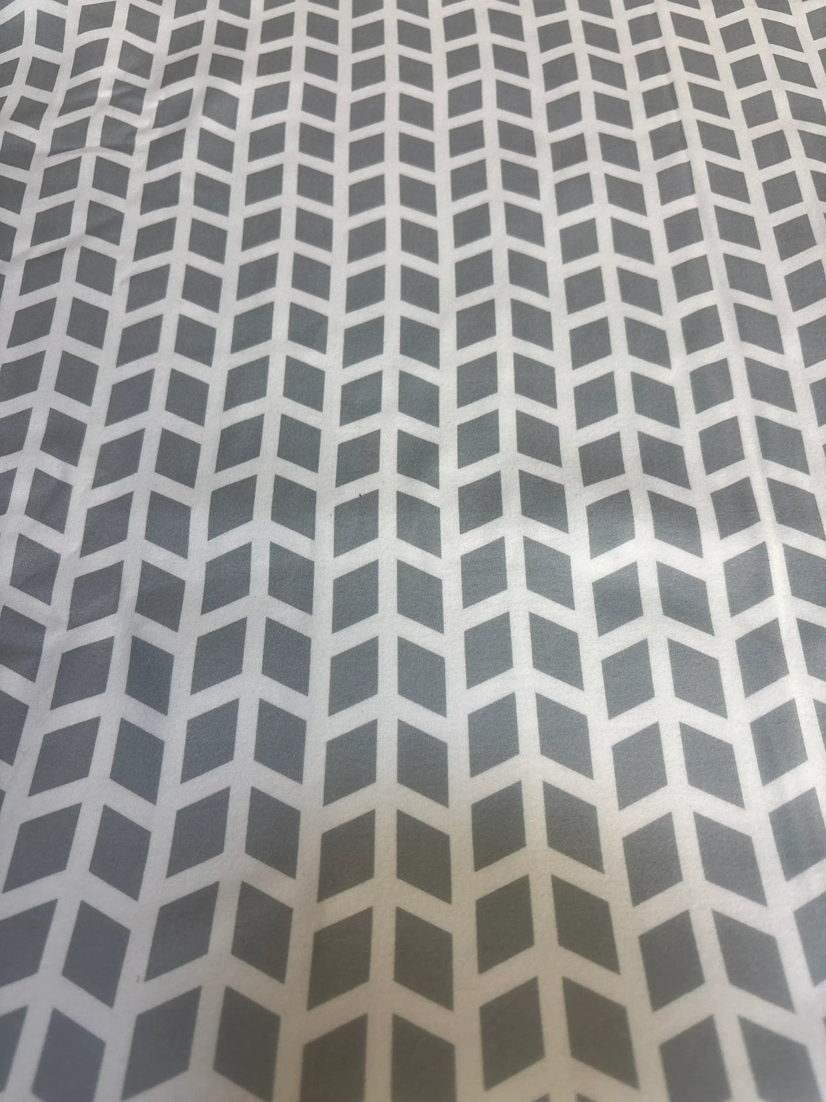 Close-up of KeaBabies Warmzy car seat cover Kite showing gray chevron geometric pattern on soft white fabric