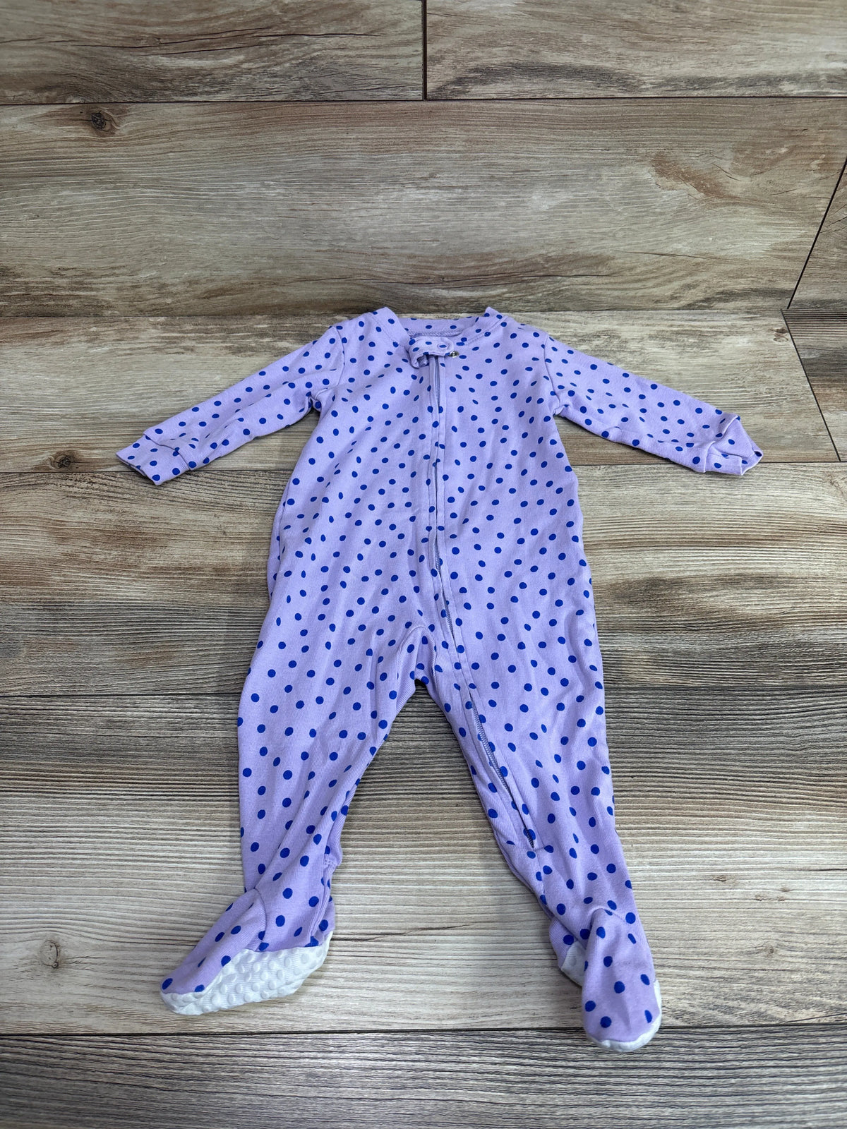 Amazon Essentials purple polka dot baby sleeper for size 3-6 months on a wood floor