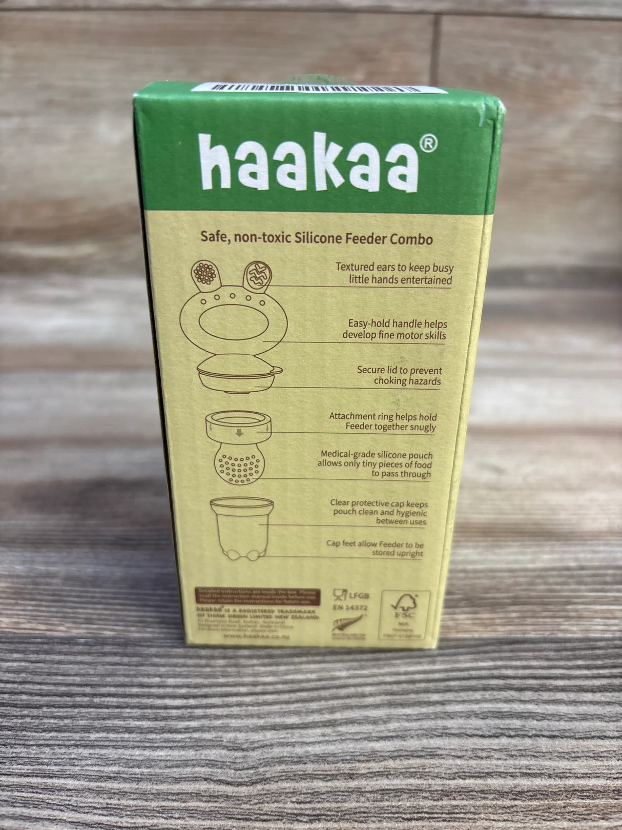 Front view of Haakaa Freeze-N-Feed Mini Combo box showcasing product diagram and feature callouts on wooden table background