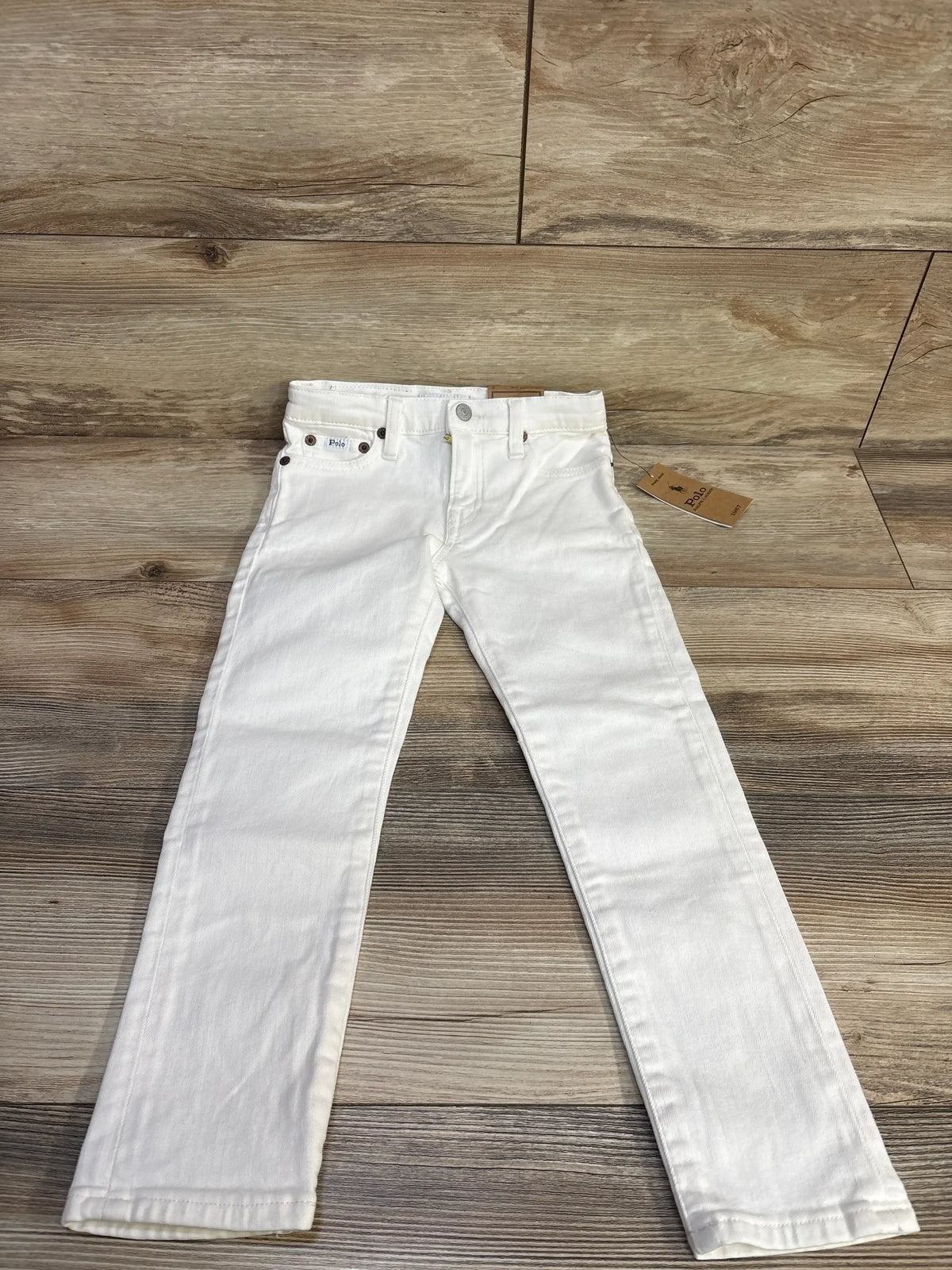 Front view of white toddler Ralph Lauren Sullivan slim stretch jeans size 5T showing slim fit, five-pocket styling on wood floor background