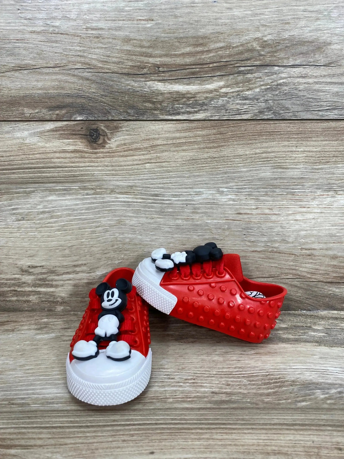Side view of Mini Melissa Polibolha x Disney red toddler sneaker with bubble-texture upper and Mickey accent