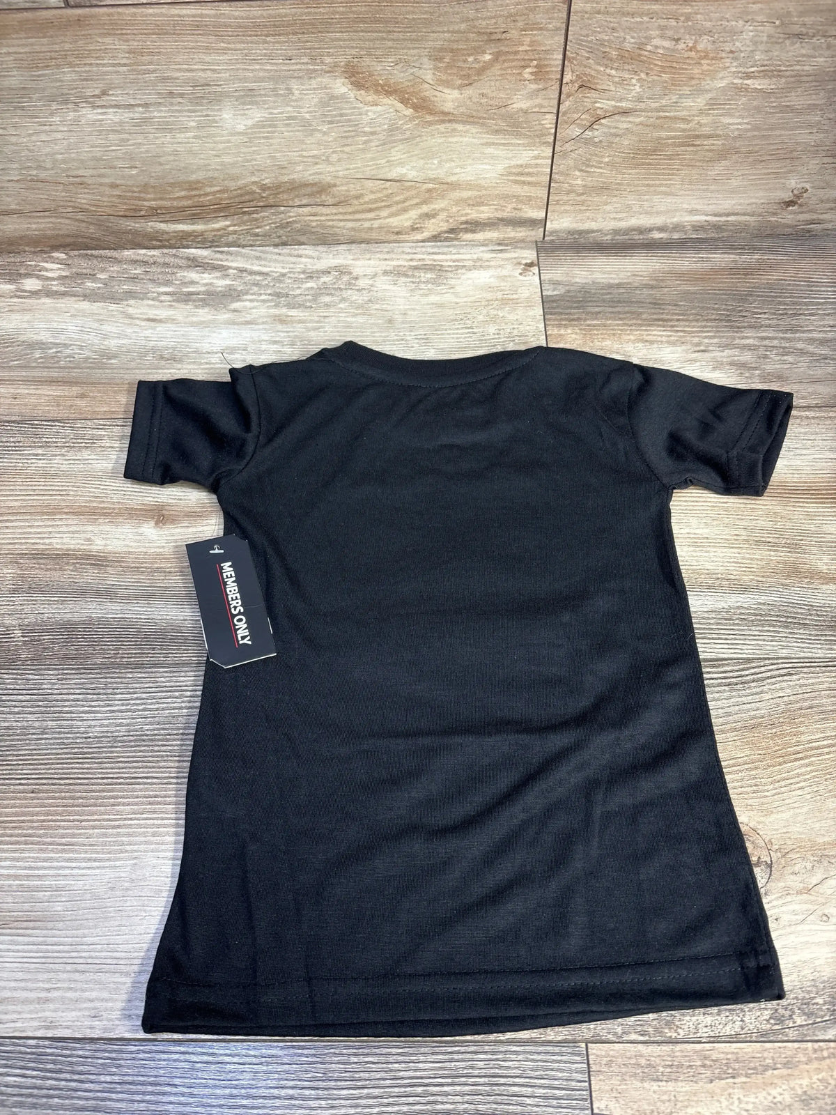 Black short-sleeve t-shirt with Members Only tag on wooden floor background