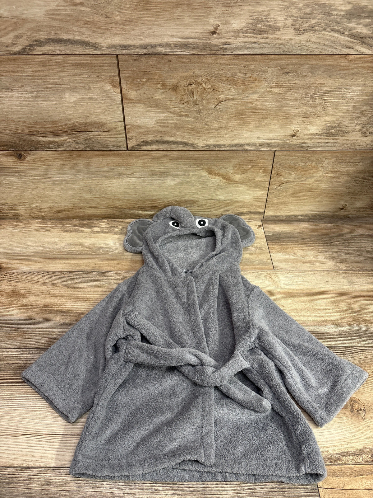 Grey Sunny zzzZZ hooded elephant baby bath robe for size 0-12m on a wooden background