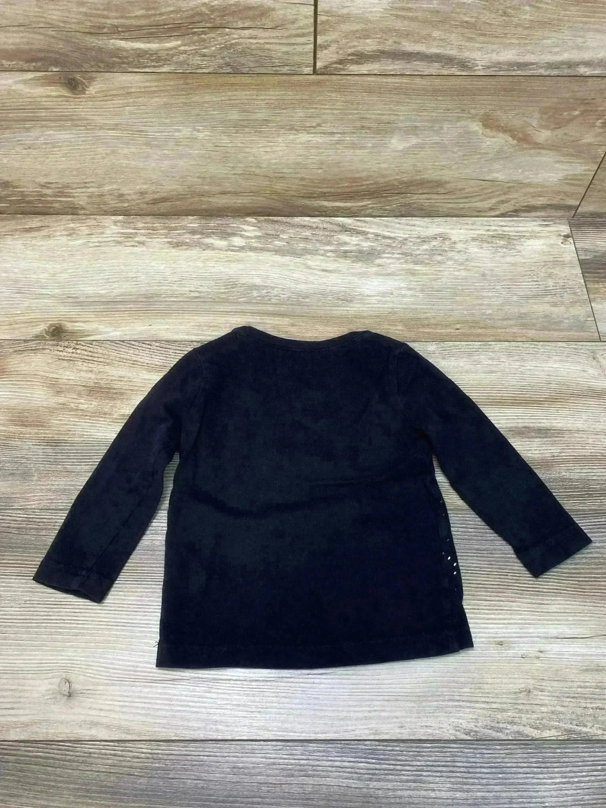 Back view of Appaman Space Milk graphic tee 12-18M showing black long sleeves and plain back on light wood background