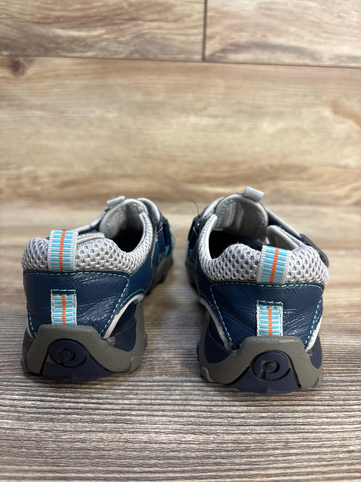 Rear view of Pediped Flex Canyon blue water sandals with orange-striped heel pull tabs and gray rubber soles