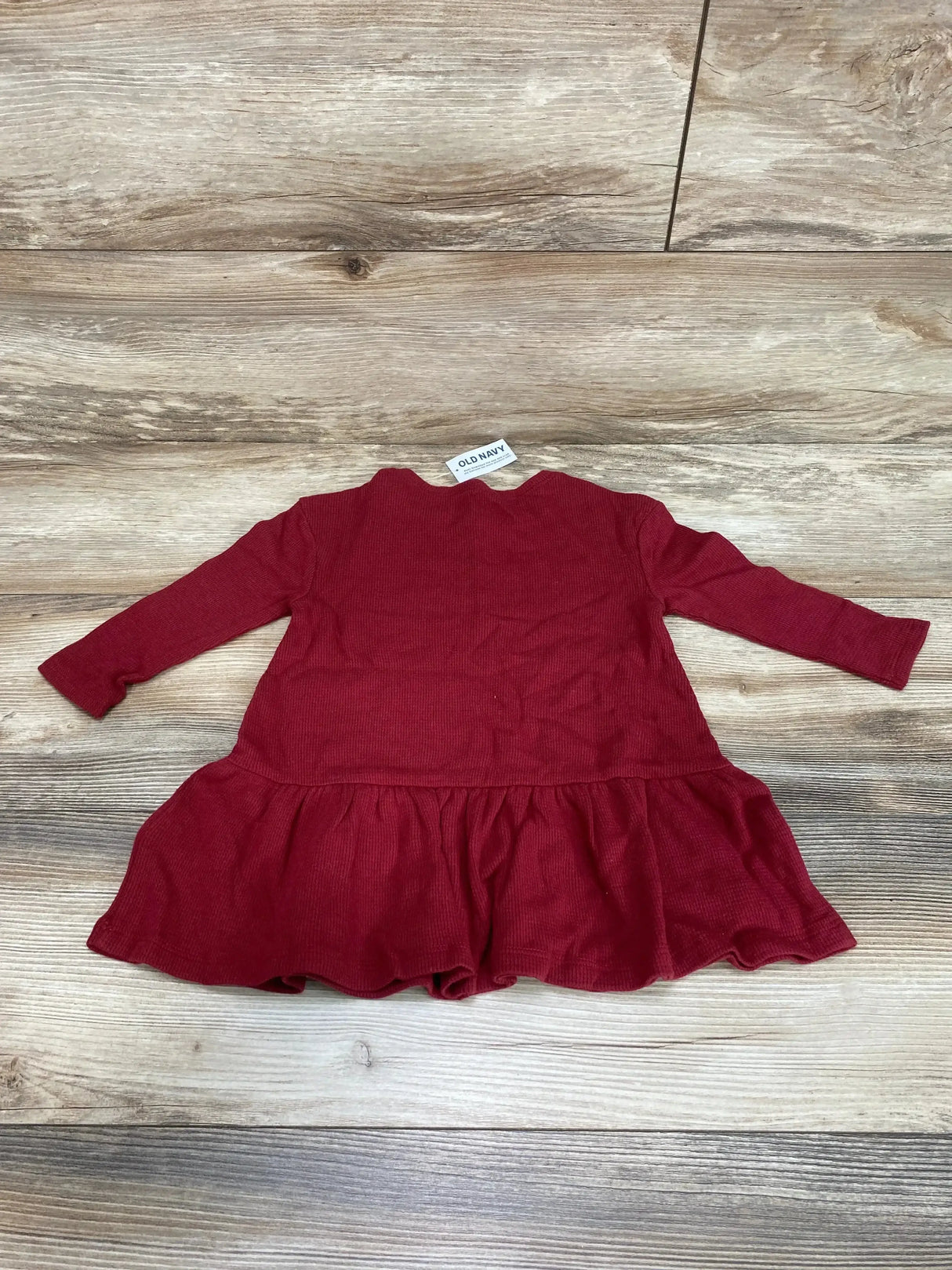 Back view of NEW Old Navy peplum thermal dress size 18-24m in crimson long sleeve with ruffled hem on wood plank floor