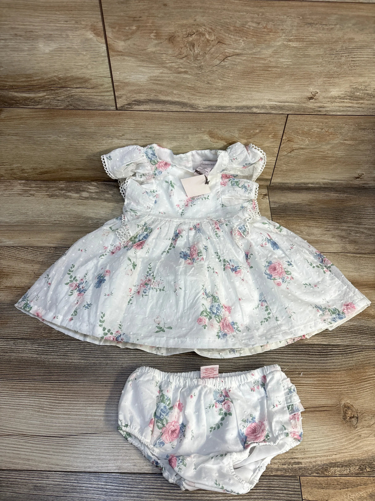 White floral baby dress with matching bloomers, soft cotton, ruffled sleeves, perfect for newborns and infants