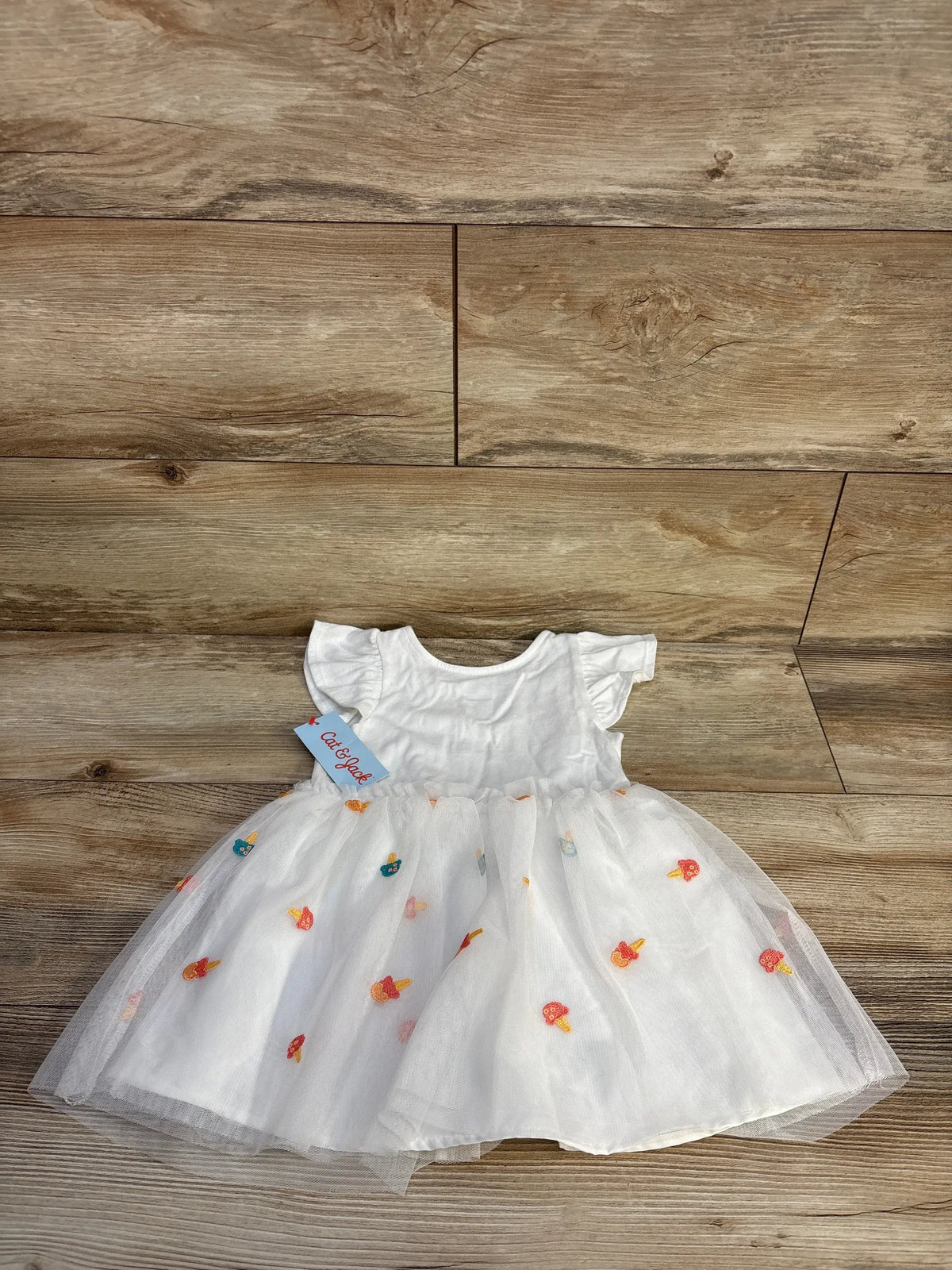 White Cat & Jack ice cream tank tulle dress for toddlers on a wood background