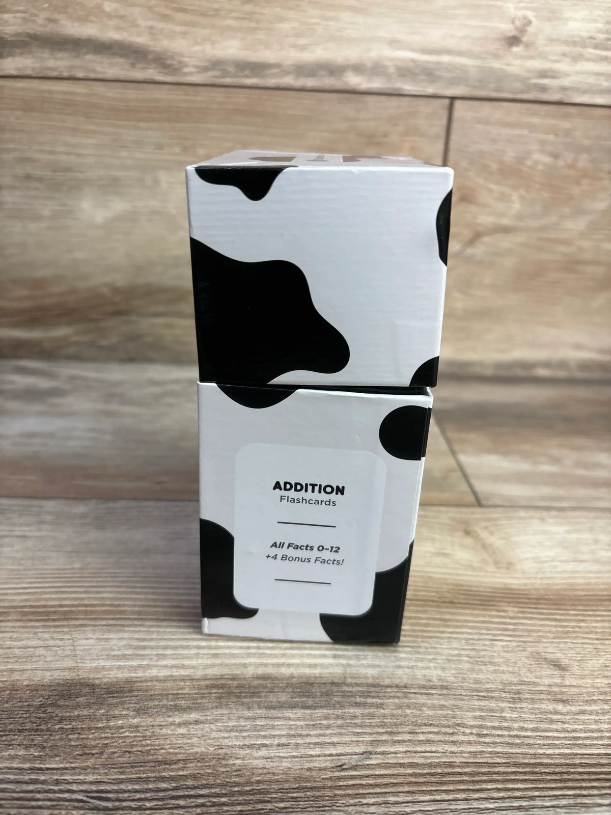Front view of Think Tank Scholar addition flashcard box showing ADDITION Flashcards label and black and white cow print