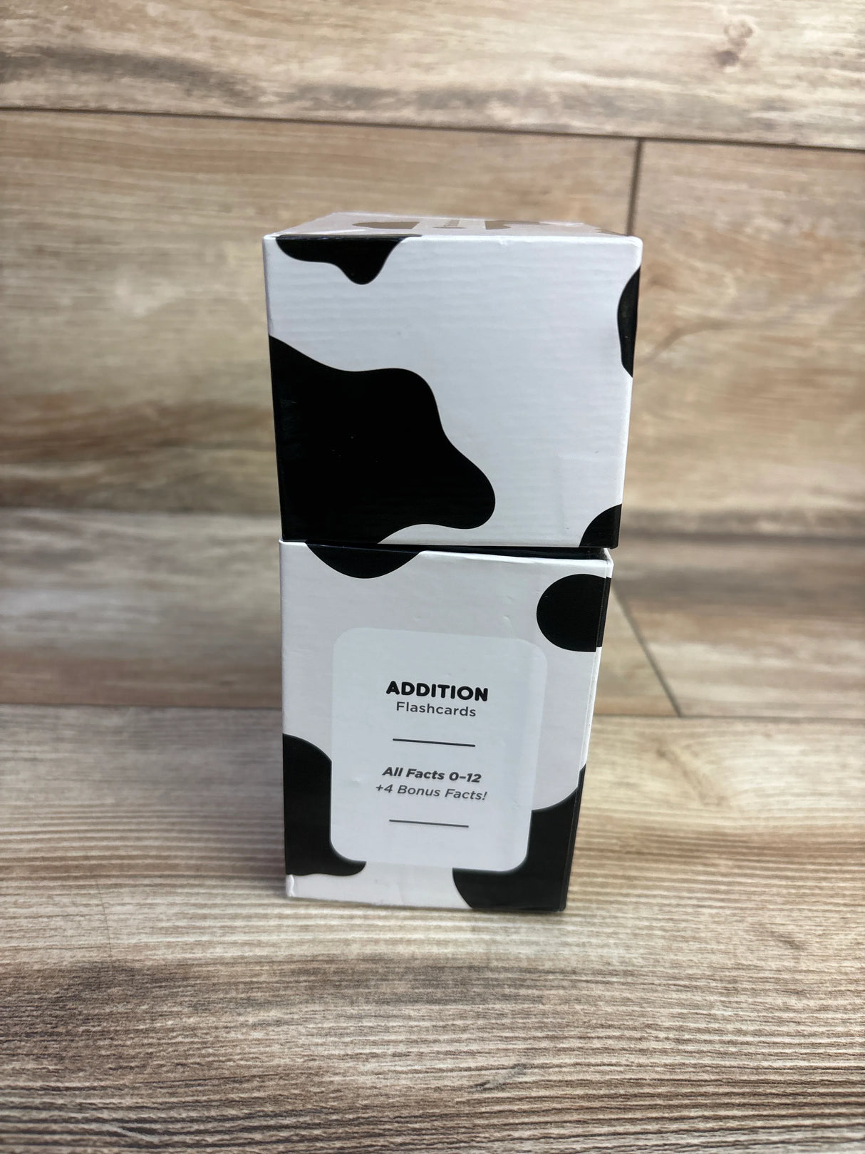 Front view of Think Tank Scholar addition flashcard box showing ADDITION Flashcards label and black and white cow print