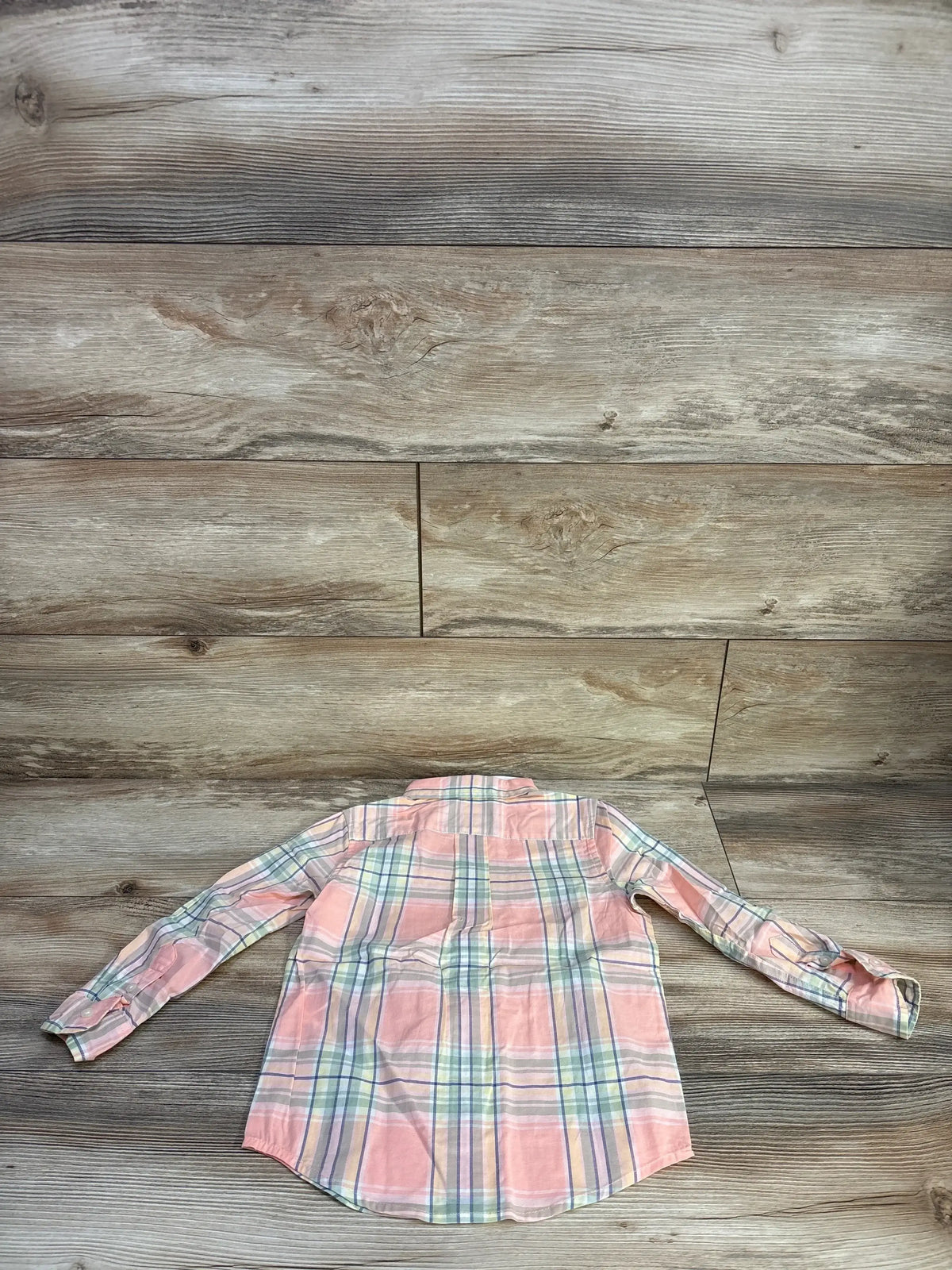 Back view of Janie & Jack toddler button-down shirt, pink plaid with pastel stripes, long sleeves, laid flat on wood background, size 3T