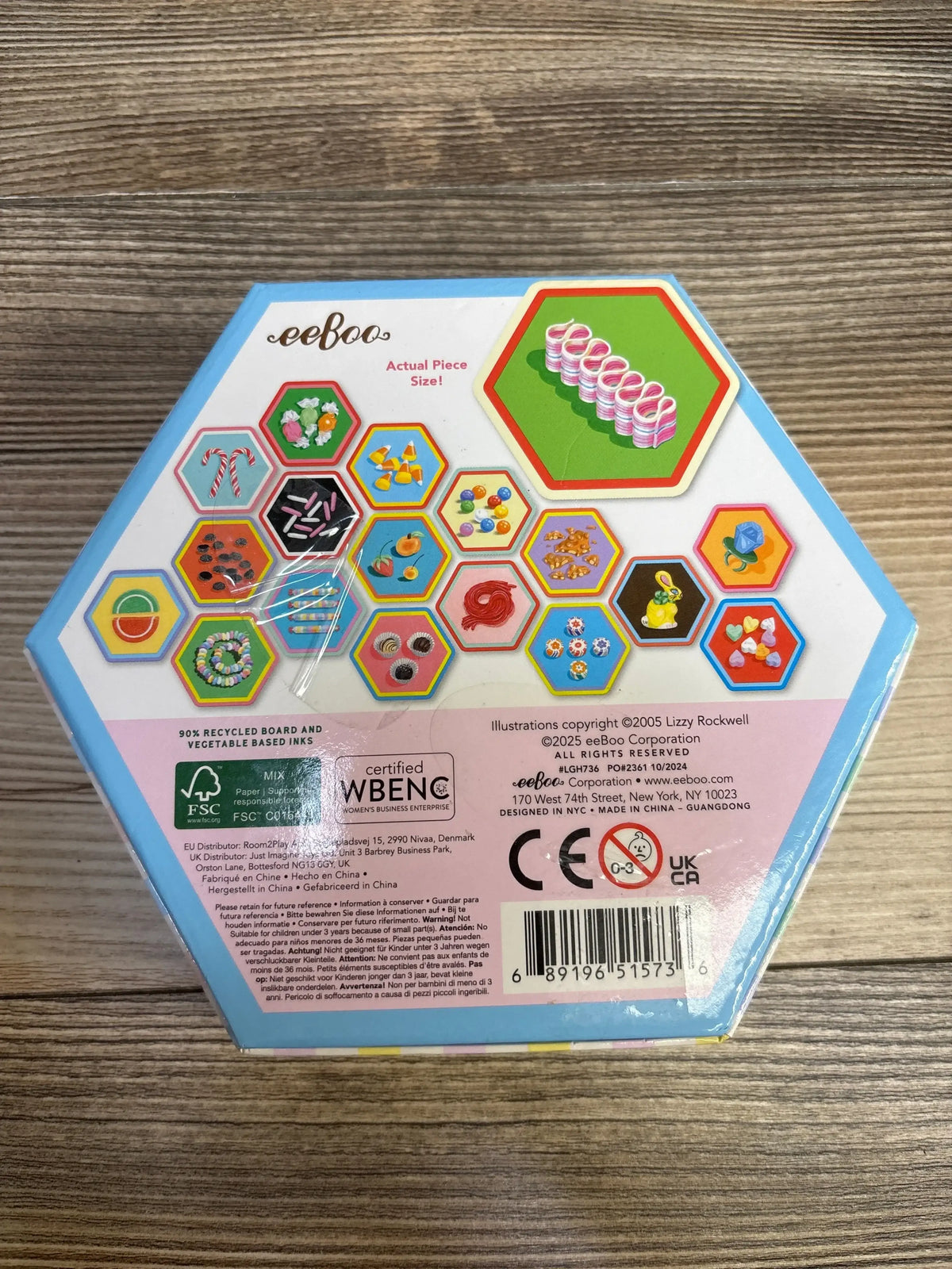 Back of eeboo Candy Memory & Matching Game for ages 3+ in hexagonal box showing sample candy tile illustrations on wood plank floor