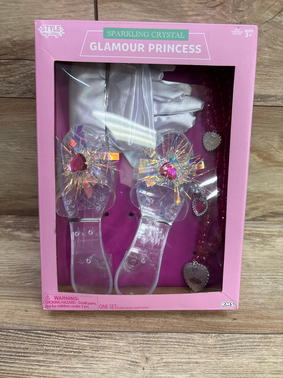 Front view of Style My Way Glamour Princess accessory set with crystal-decorated clear sandals, gloves, and jewelry in pink box