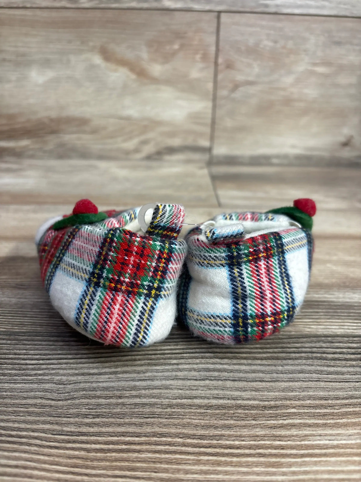 Plaid baby booties with red pom-poms, soft infant shoes for newborns, holiday-themed baby clothing