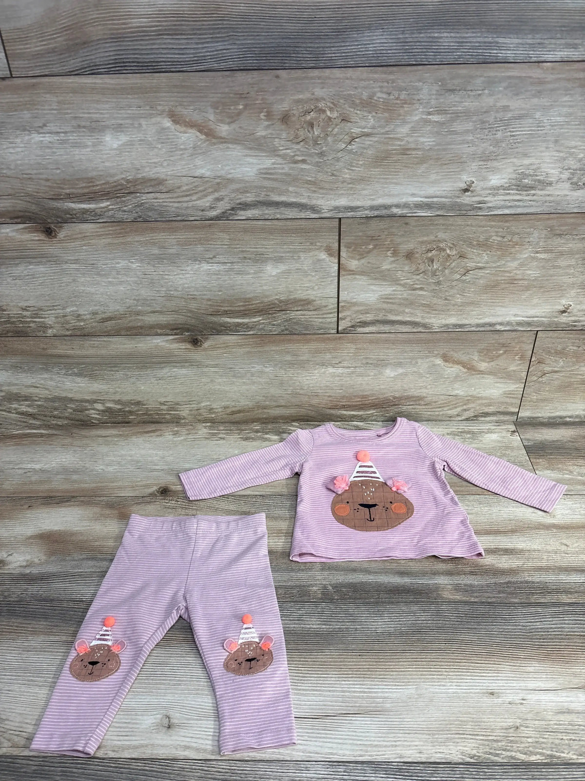 Pink striped toddler outfit with long sleeve top and pants featuring bear face appliques with party hats