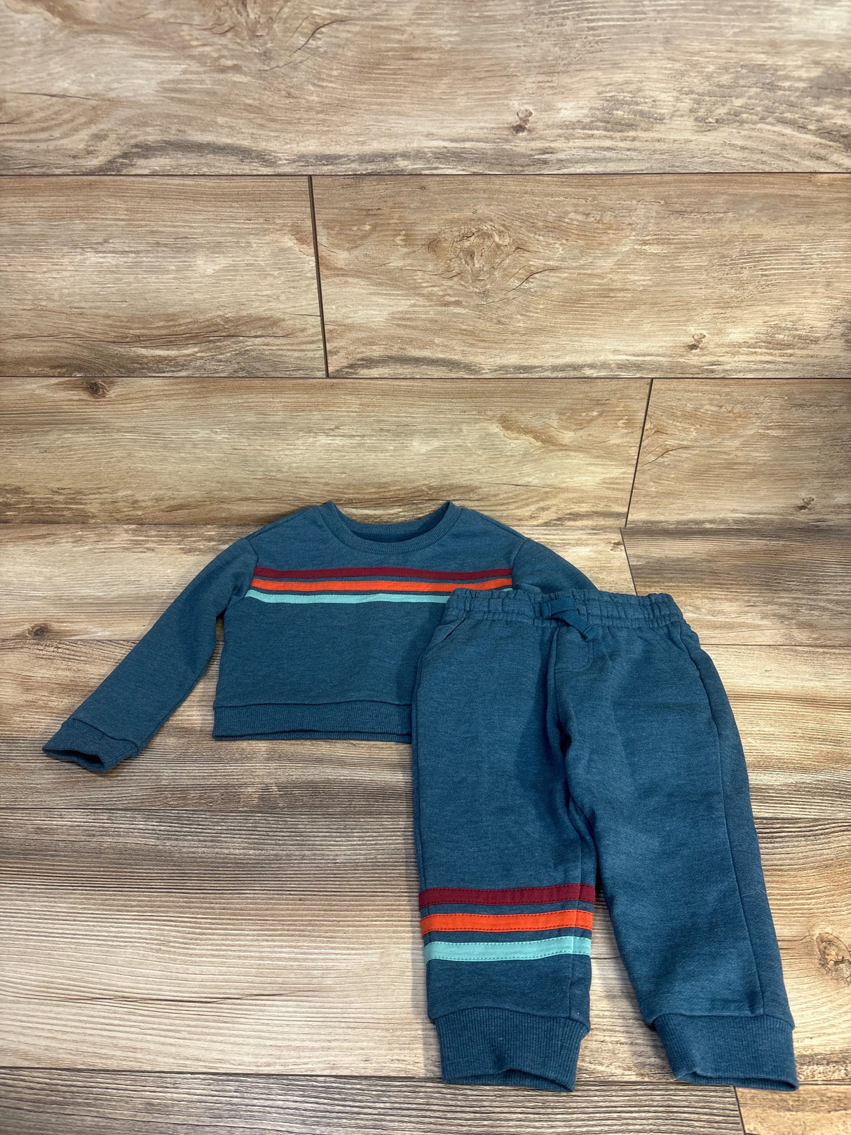 Blue kids striped sweatshirt and joggers set on wooden floor