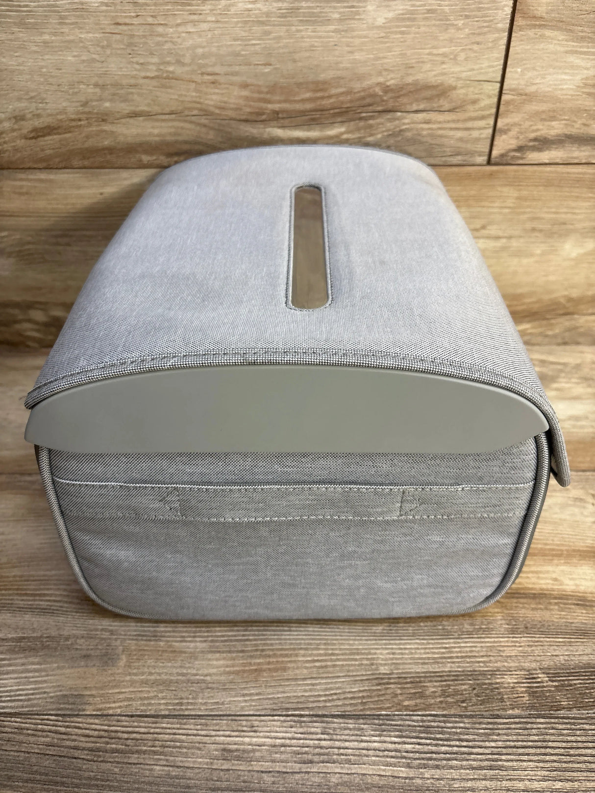 Top-front view of Munchkin 59S UV Cleaning Bag showing gray fabric and centered rectangular top opening on wood backdrop