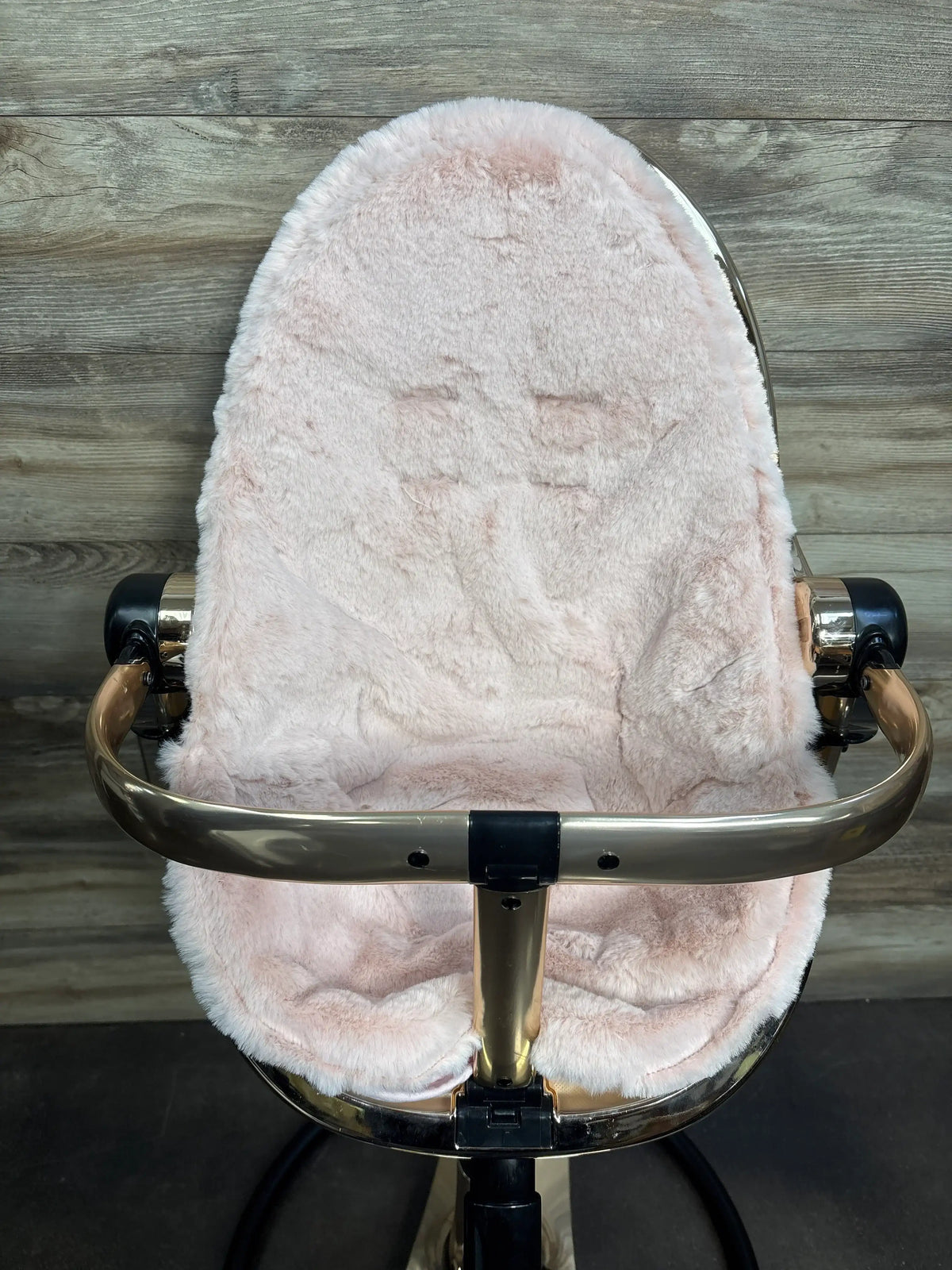 Front view of Bloom Fresco Special Edition High Chair in Rose Gold with plush pink seat on wood floor