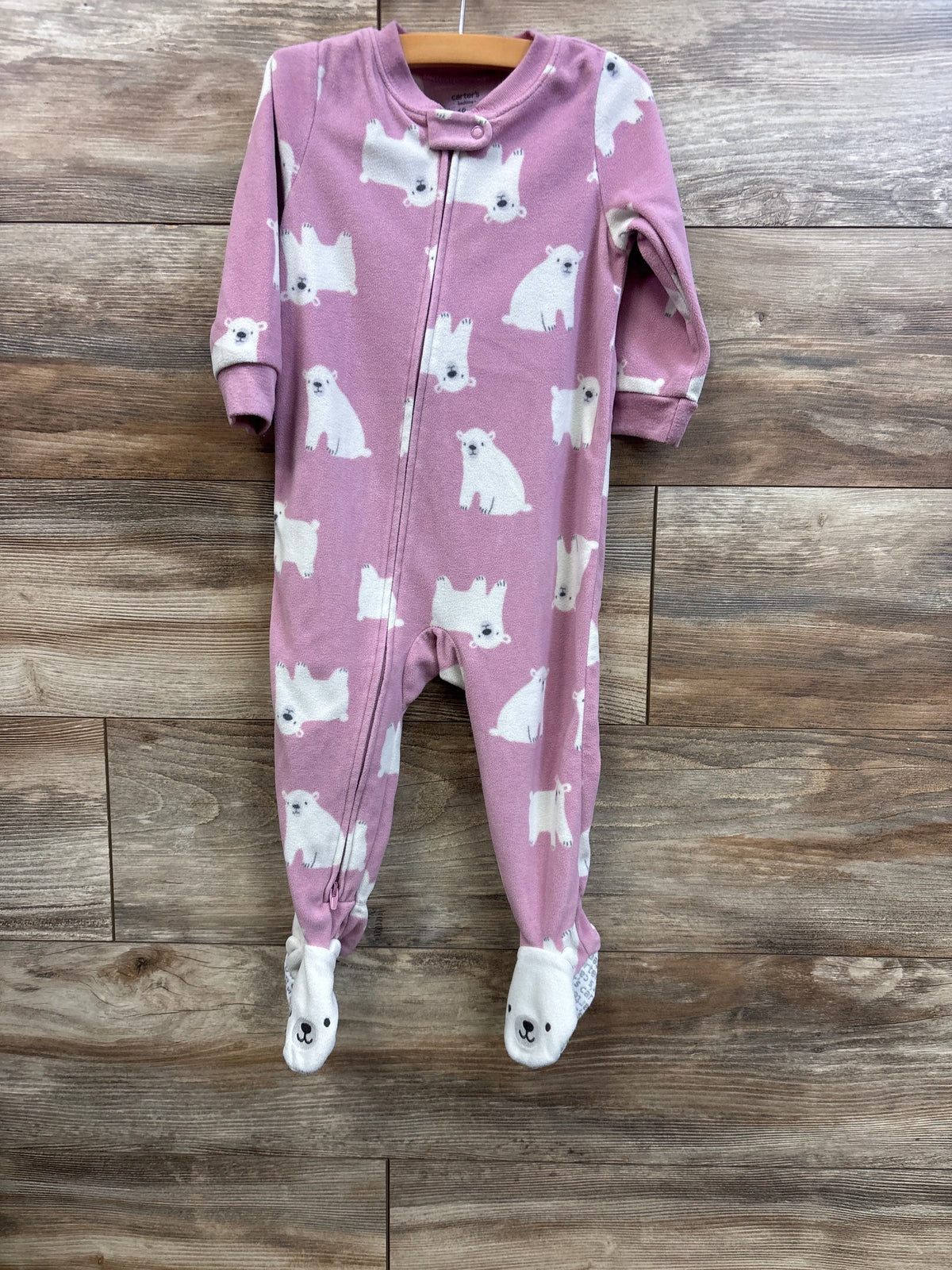 Front view of Carter’s pink footed blanket sleeper, 18M, zip front and snap collar, white polar bear print, fold-over bear-face feet on wood background