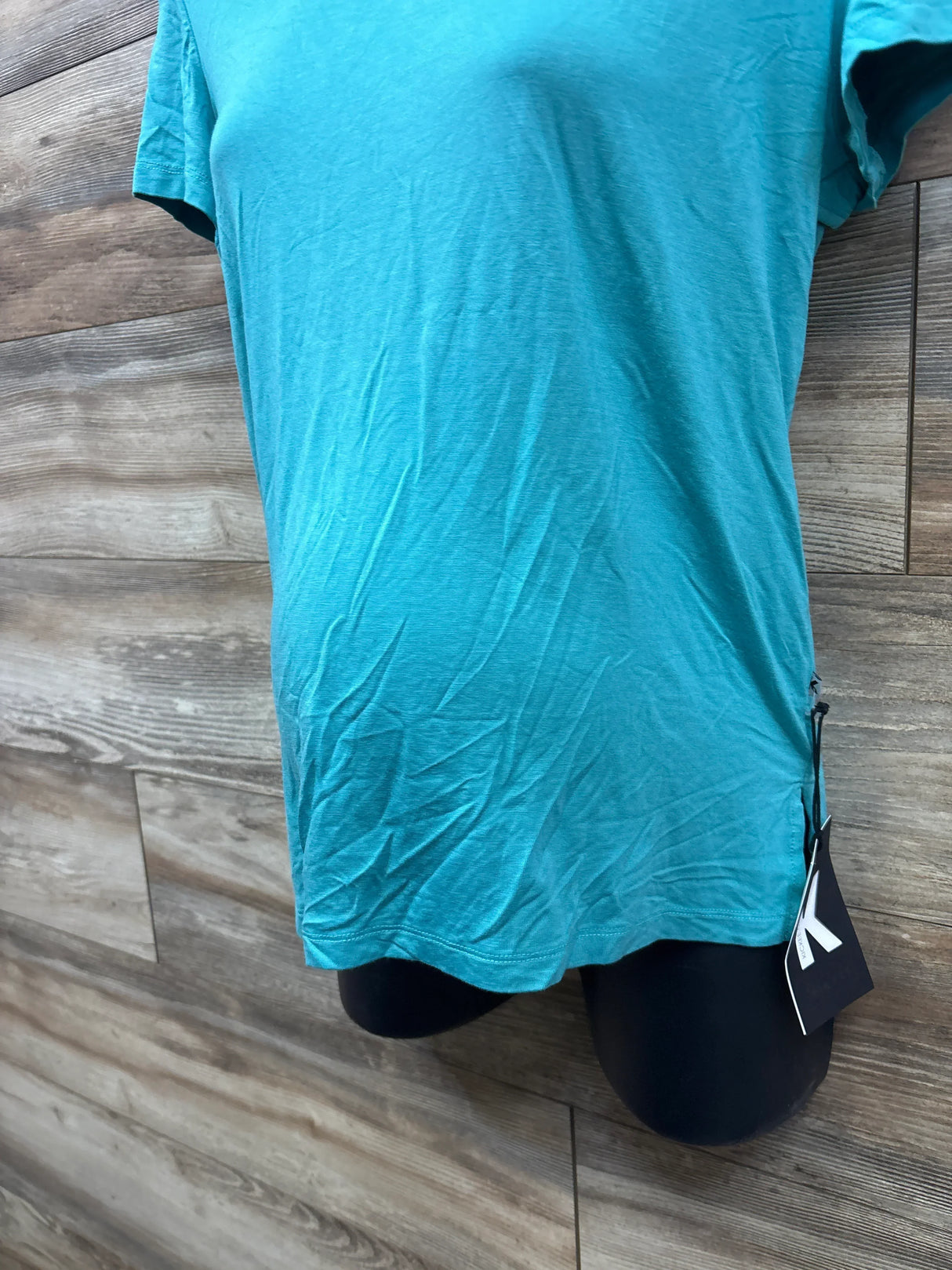 Teal maternity t-shirt on mannequin with tag, wood backdrop, gently used kids clothes