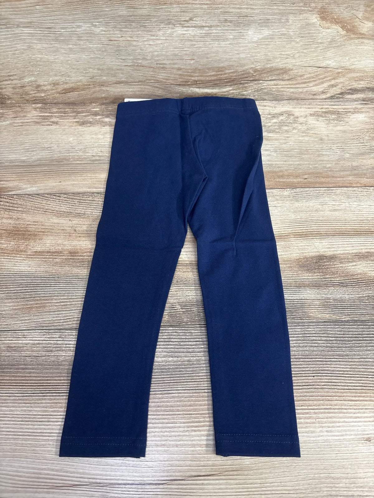 Navy blue toddler leggings on wood background, children's resale clothing