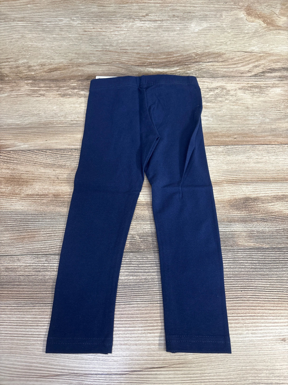 Navy blue toddler leggings on wood background, children's resale clothing
