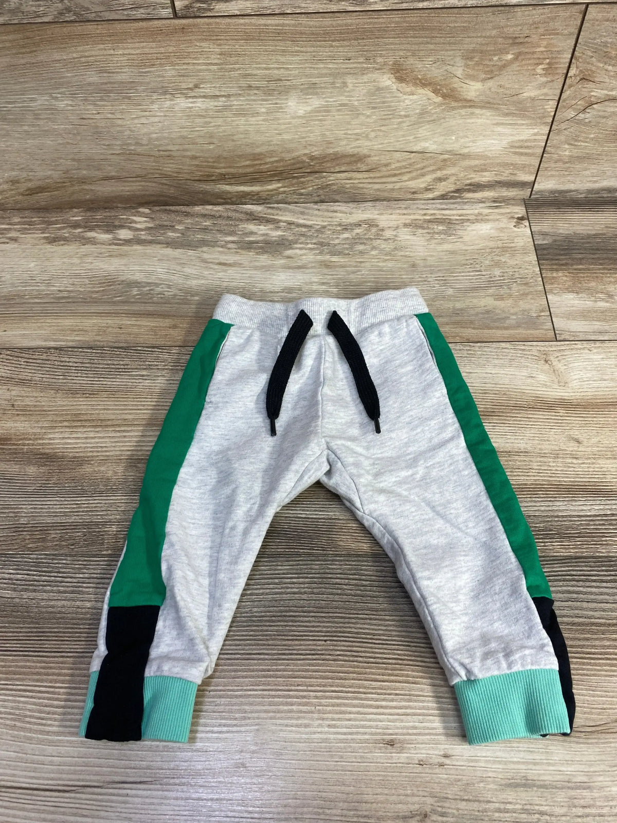 Gray toddler jogger pants with green and black side stripes, drawstring waist, ribbed cuffs