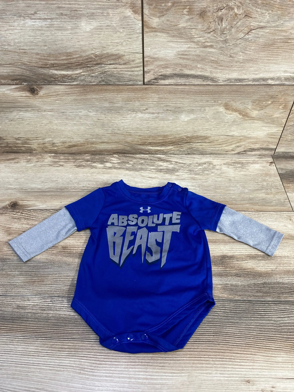 Front view of Under Armour Bodysuit Blue sz 3/6m showcasing round neck, long sleeves, and Absolute Beast graphic