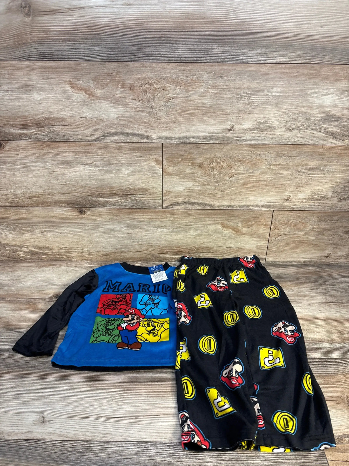 Super Mario kids pajamas set with blue long-sleeve top and black pants featuring Mario graphics