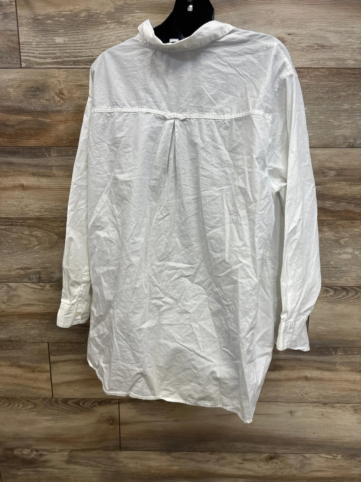 Back view of Old Navy maternity Henley knit shirt in white showcasing center back pleat and high collar on wooden background