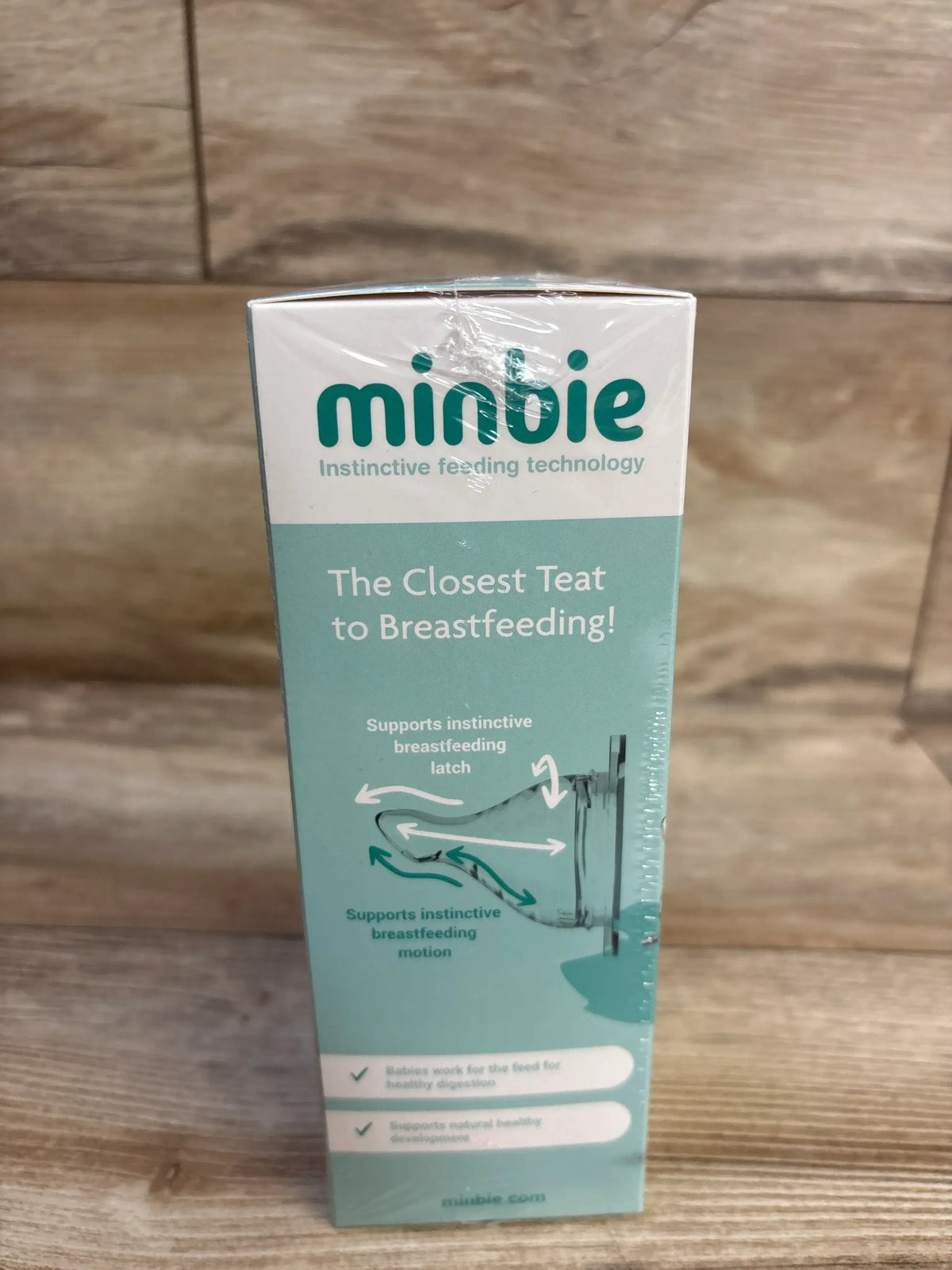Side view of NEW Minbie 6m plus Feeding Kit in sealed teal and white instinctive feeding technology box on wood plank floor
