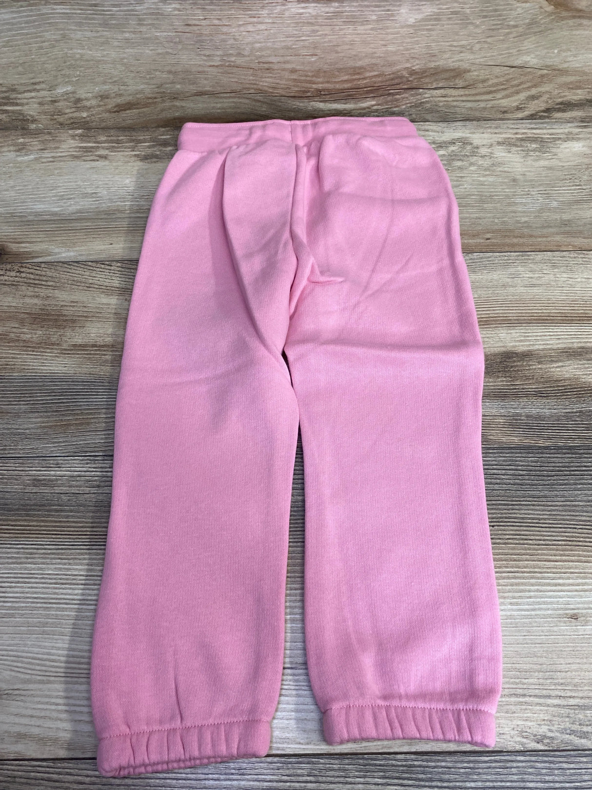 Pink toddler jogger pants on wood background, elastic waistband, gently used kids clothing