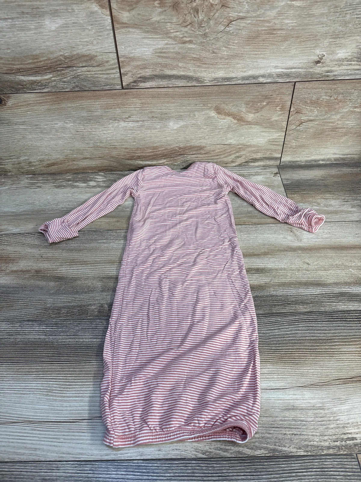 Front view of Carter’s PurelySoft striped sleep gown in pink with long sleeves and fold-over cuffs on a wood floor