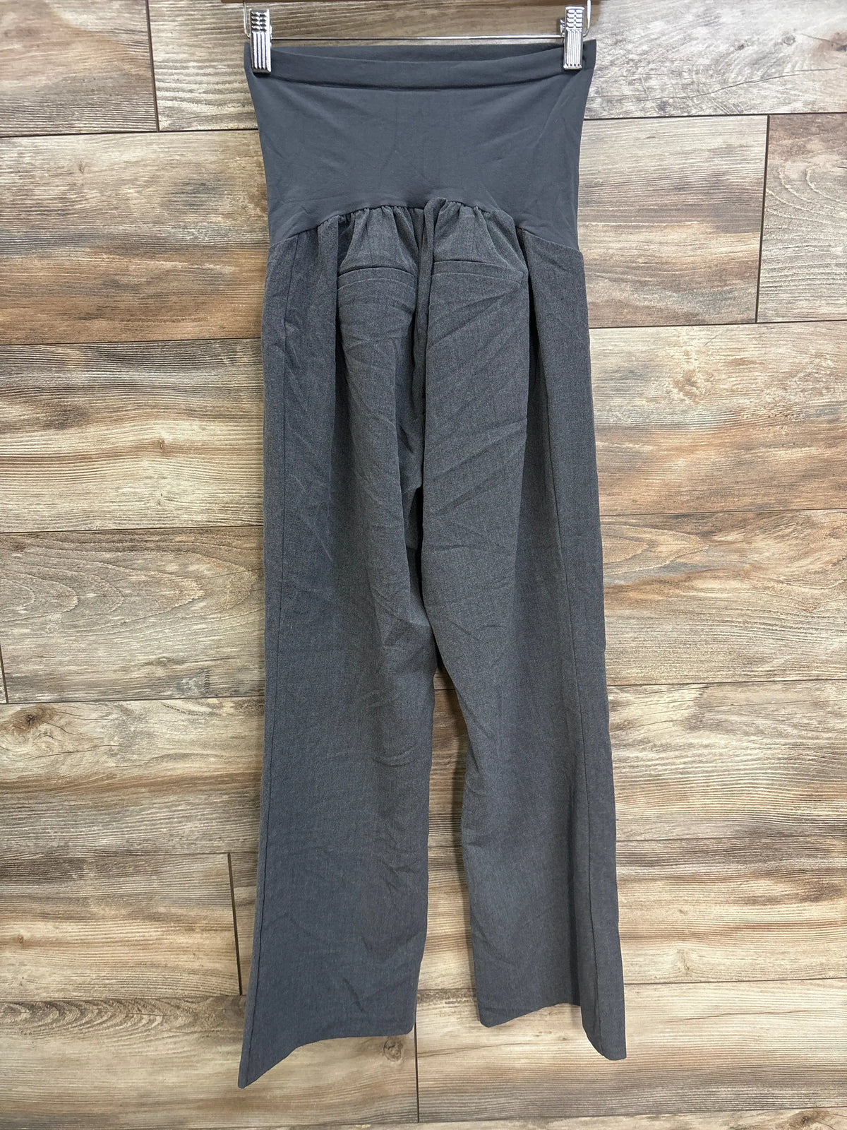 Motherhood Maternity full panel grey work pants in petite medium on a wooden background