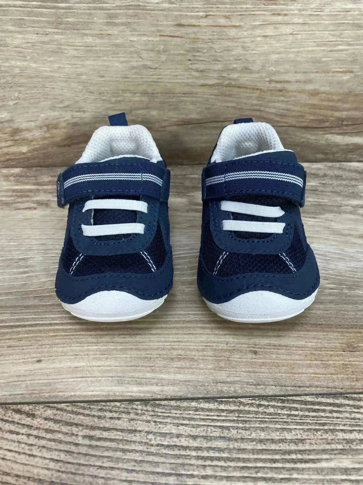 Front three-quarter view of Stride Rite Jamie toddler sneaker in navy and white showing navy upper and white rubber sole, size 3C on white background