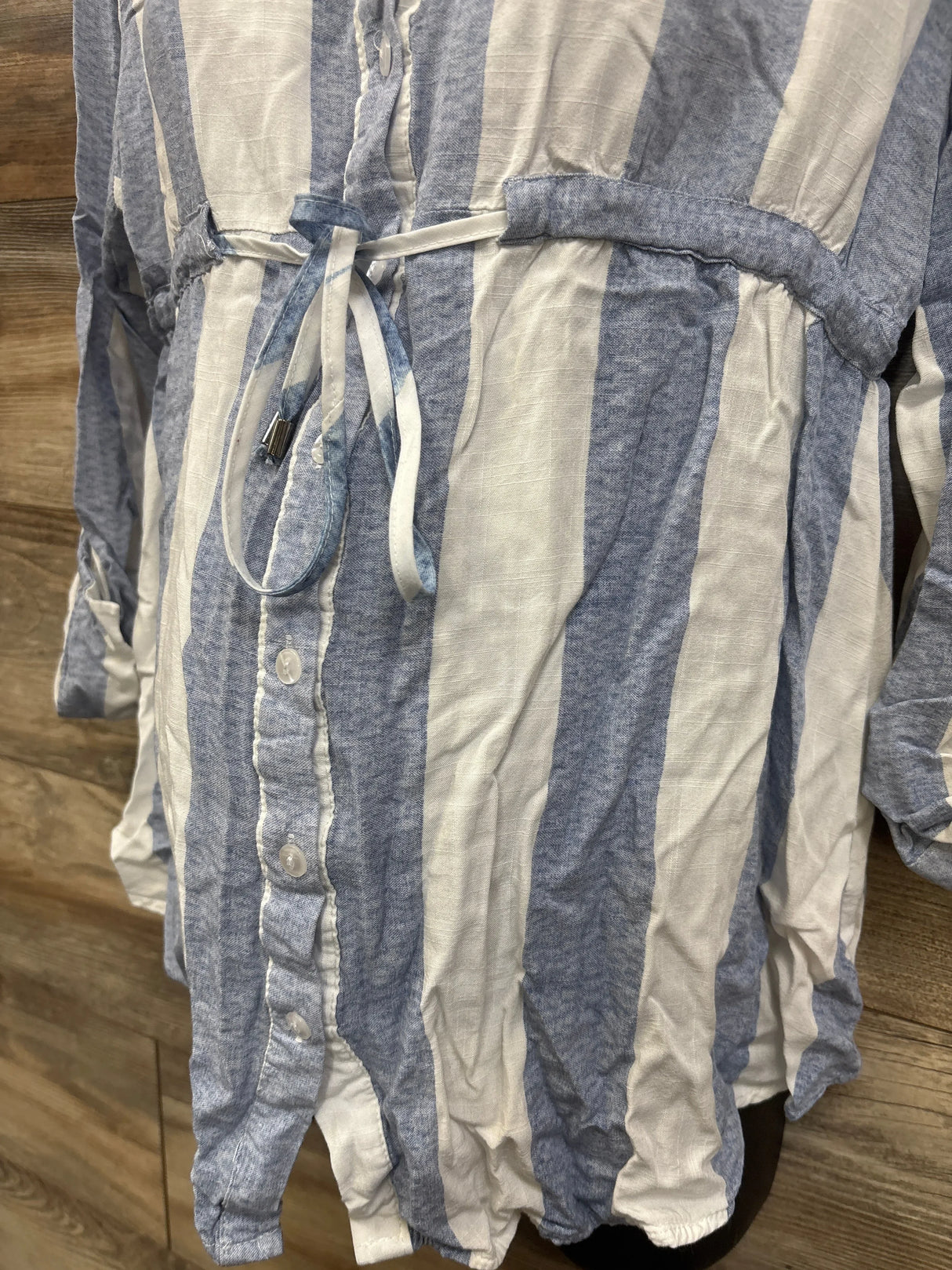 Blue and white striped maternity dress with button front and tie waist, ideal for pregnancy fashion.