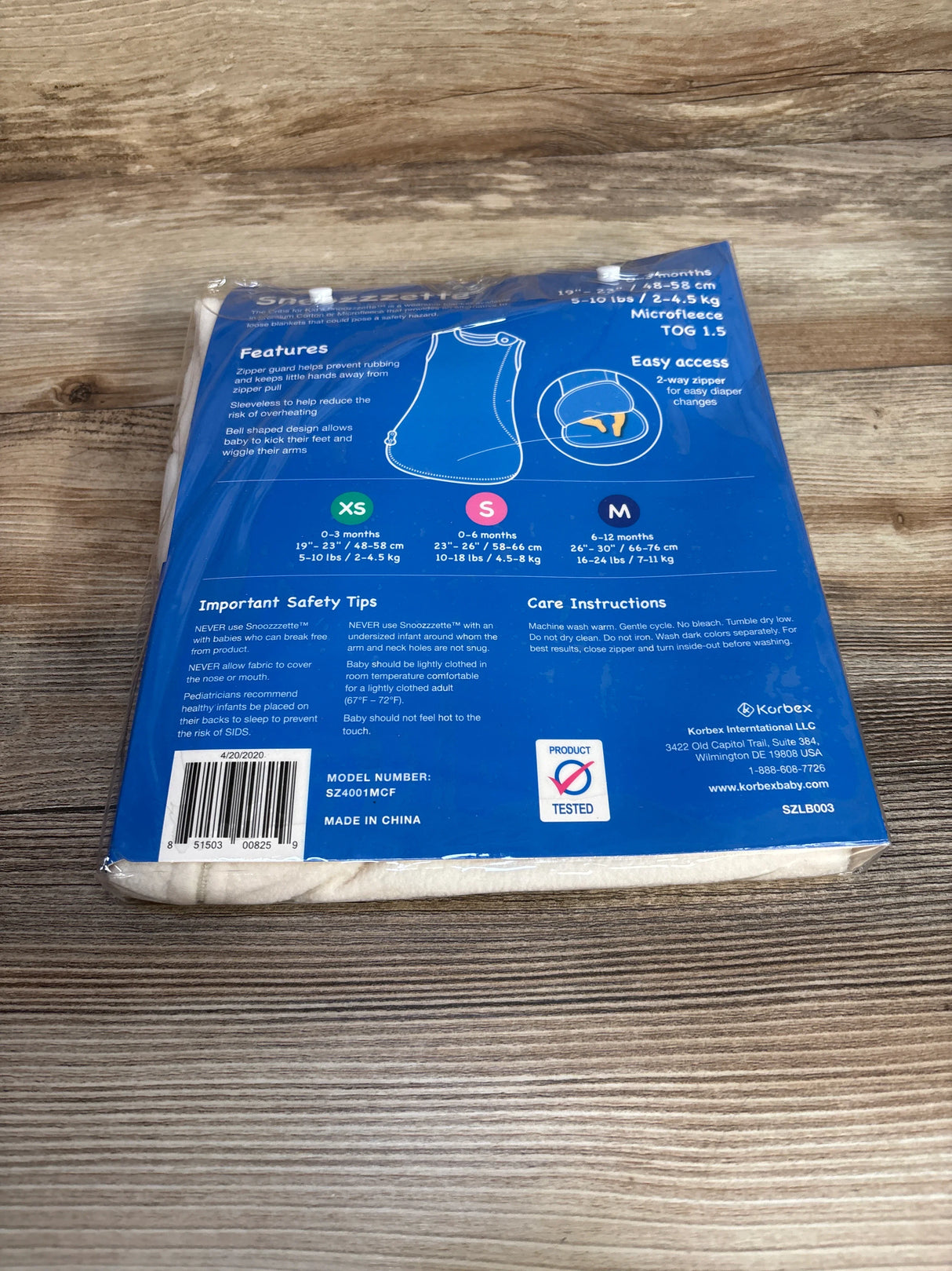 Back of Snoozelette baby sleep sack package with features, safety tips, and size chart